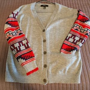 Grey cardigan with navy and red Aztec sleeves